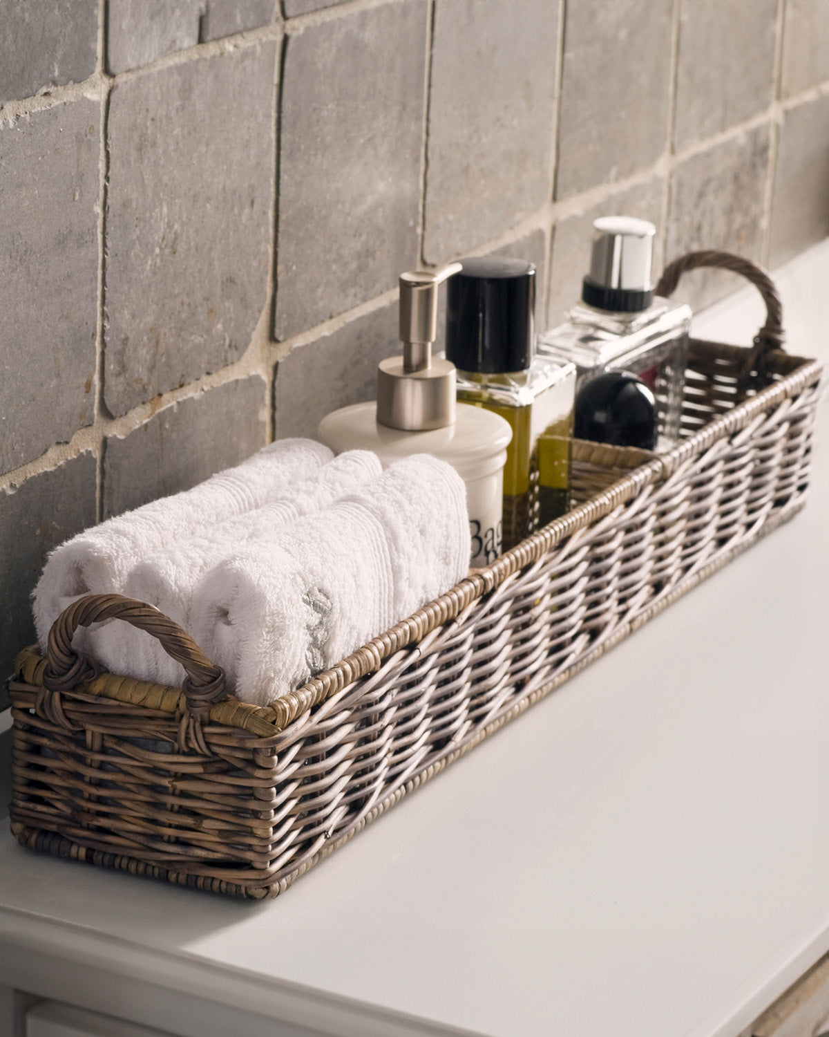 Rectangular  reed basket, decorated with towels, and soap by Riviera Maison