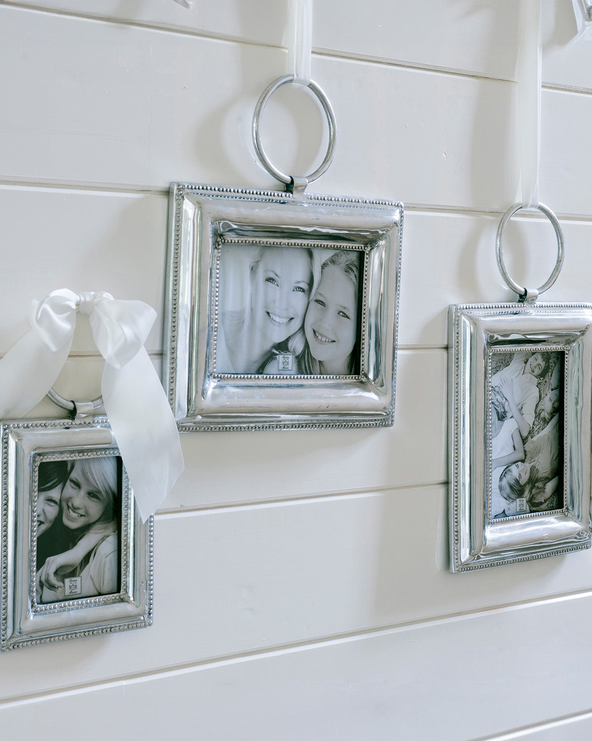 three  PHOTO FRAMES SILVER  hanging on a white wall by Riviera Maison