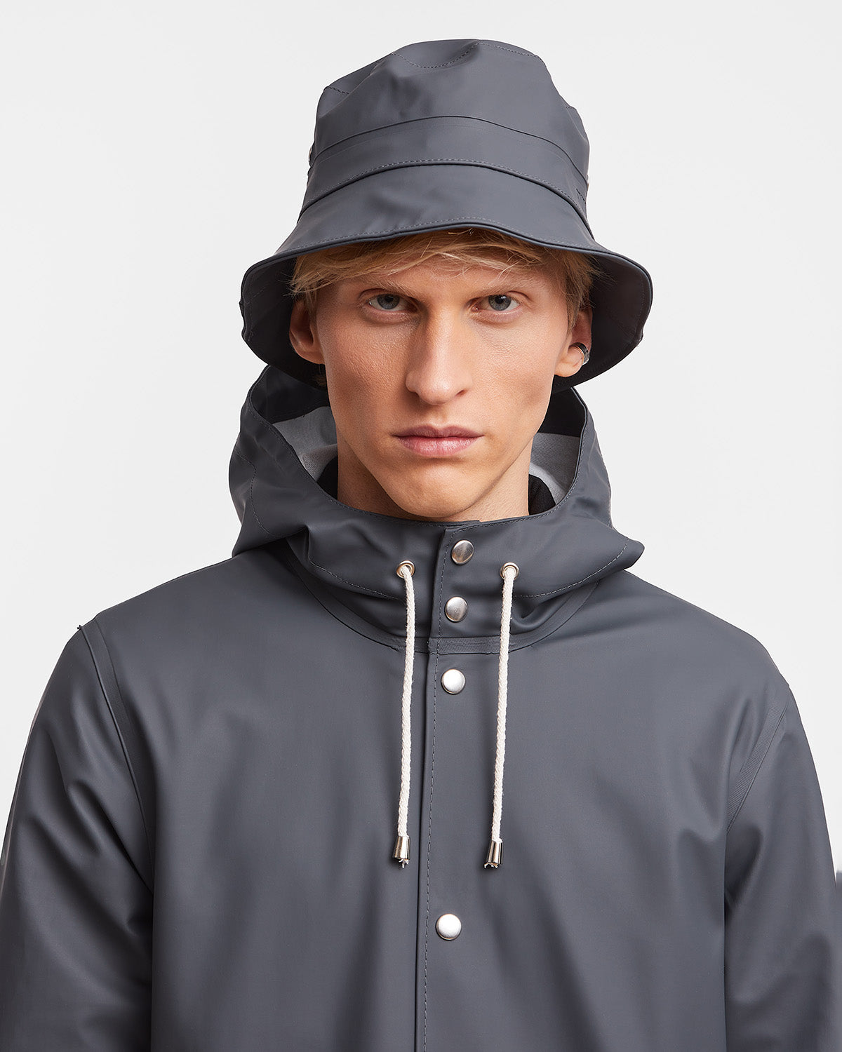 A man with Bucket Hat in color charcoal by Stutterheim seen from behind