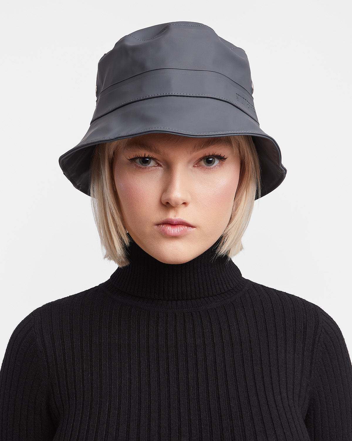 A woman with Bucket Hat in color charcoal by Stutterheim 
