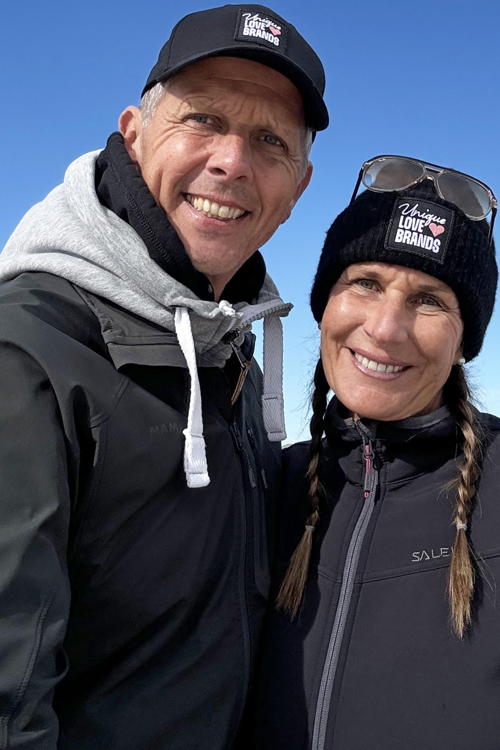 A woman and a man with black beanie and cap from unique love brands