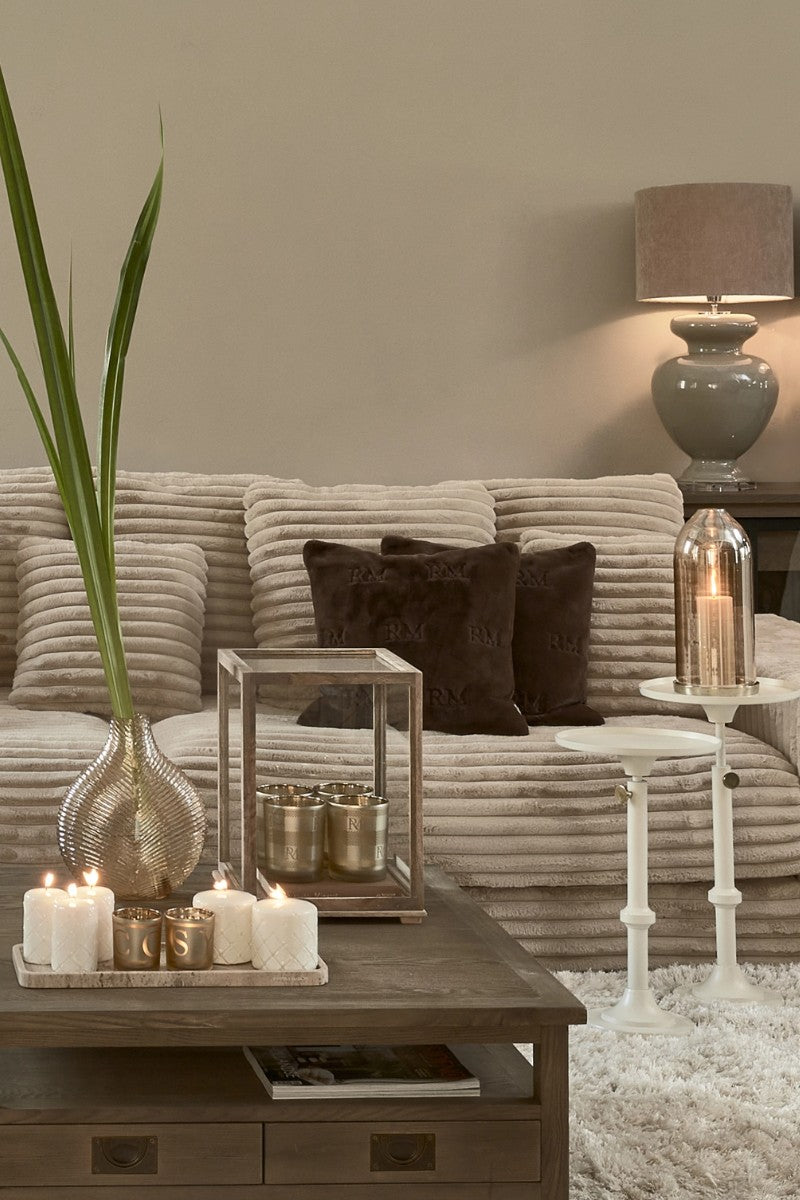 Riviera Maison Living room with sofa in color beige, table candle and decoration