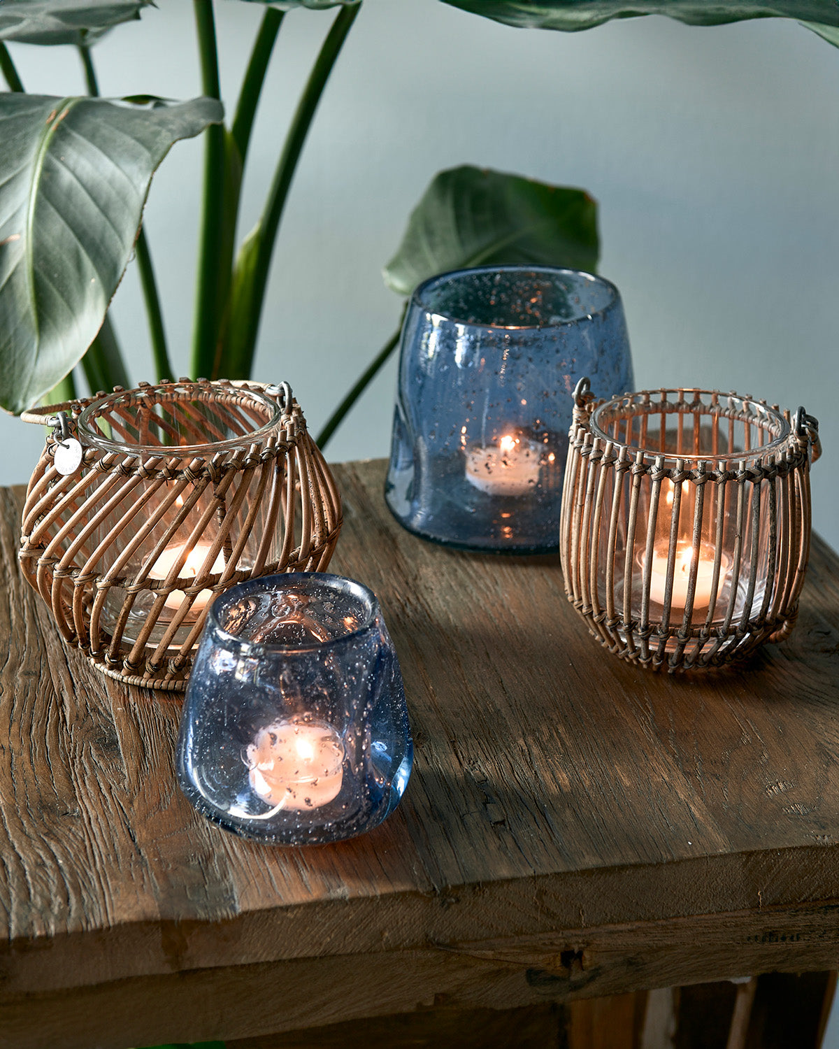 Tealight holder of sturdy glass immersed in a hand-crafted rattan basket by Riviera Maison