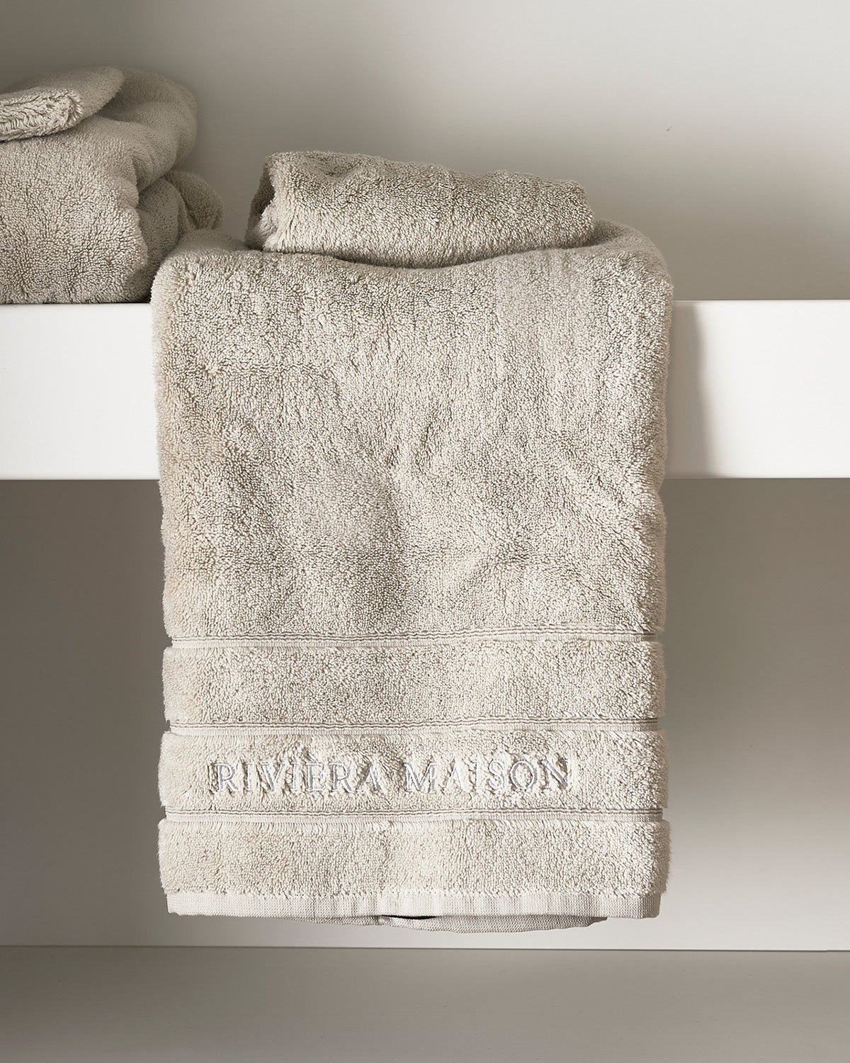 TOWELS  soft, thick, stone-colored  on a chair by Riviera Maison