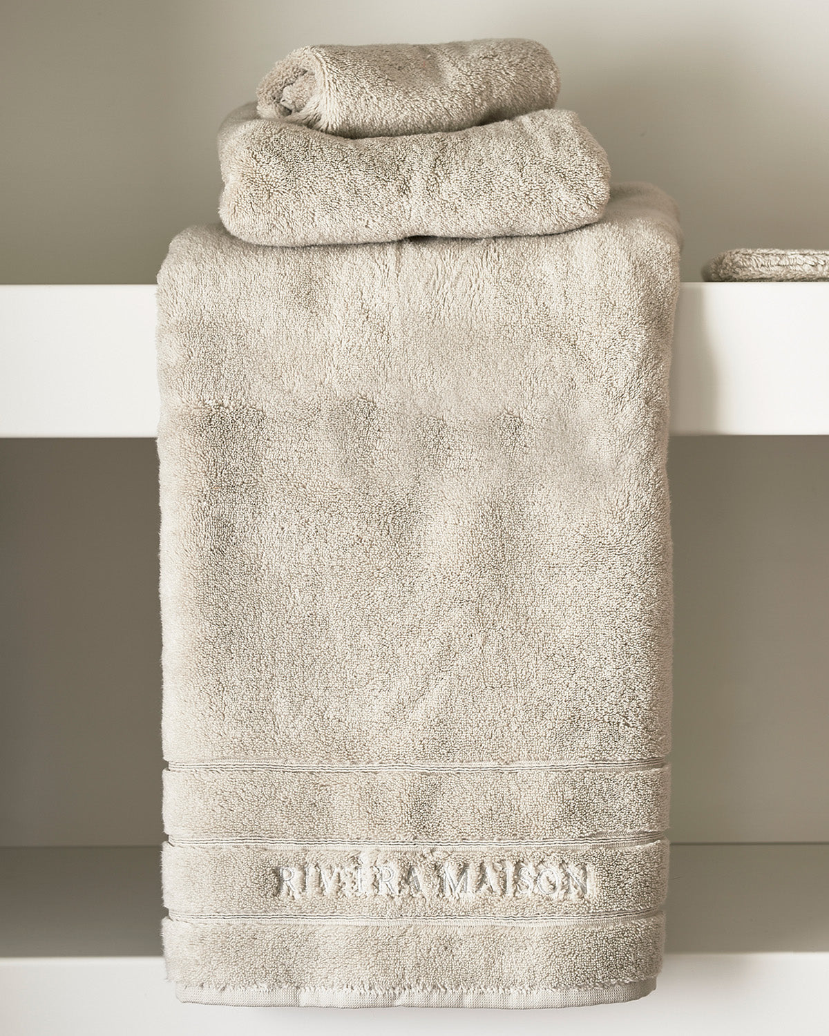 TOWELS  soft, thick, stone-colored  on a chair by Riviera Maison