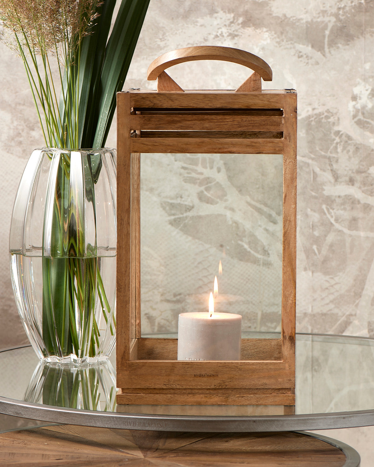 LANTERN constructed from glass and wood with candles on its iron base by Riviera Maison