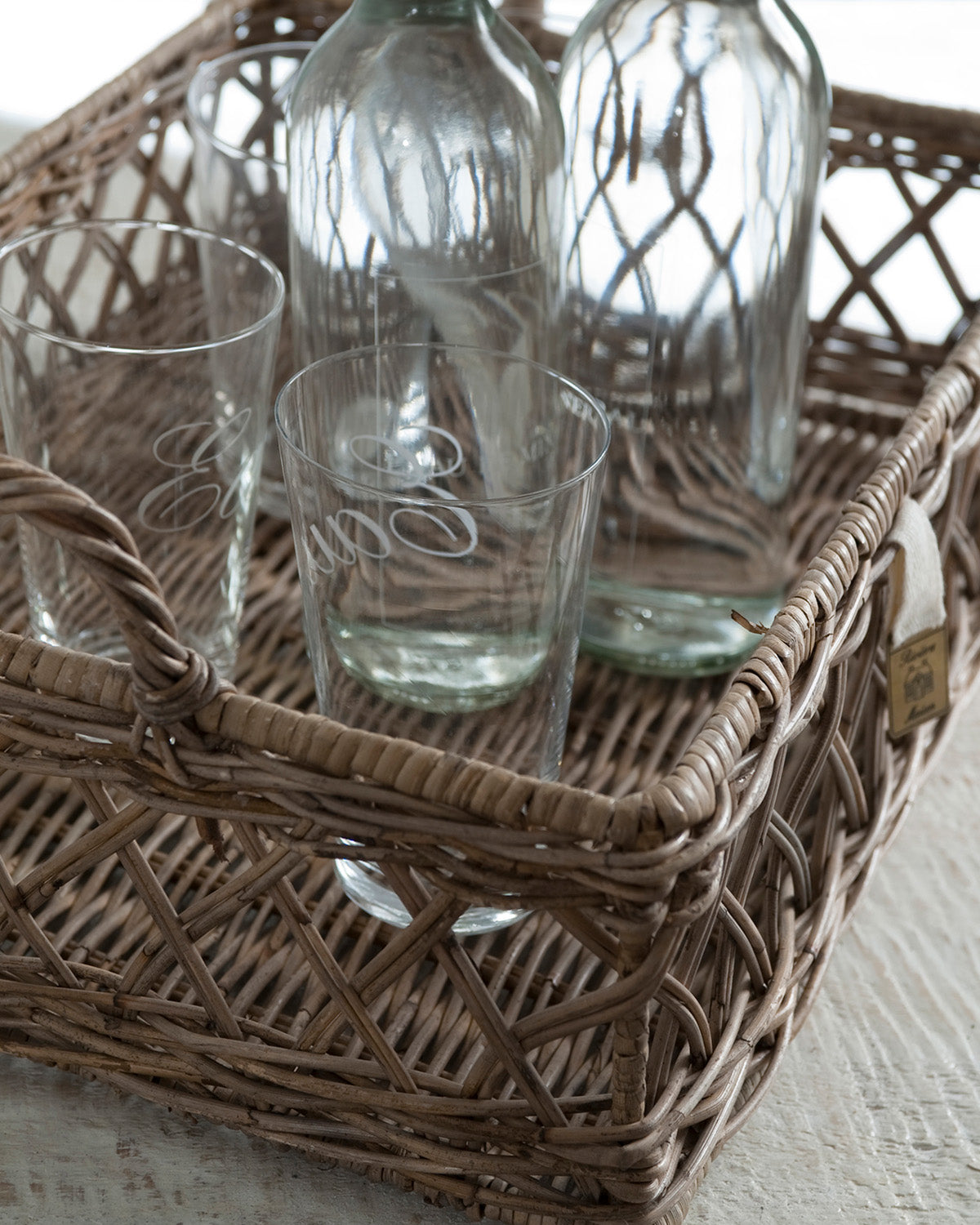 Tray made of gray reed by Riviera Maison, decorated with glasses