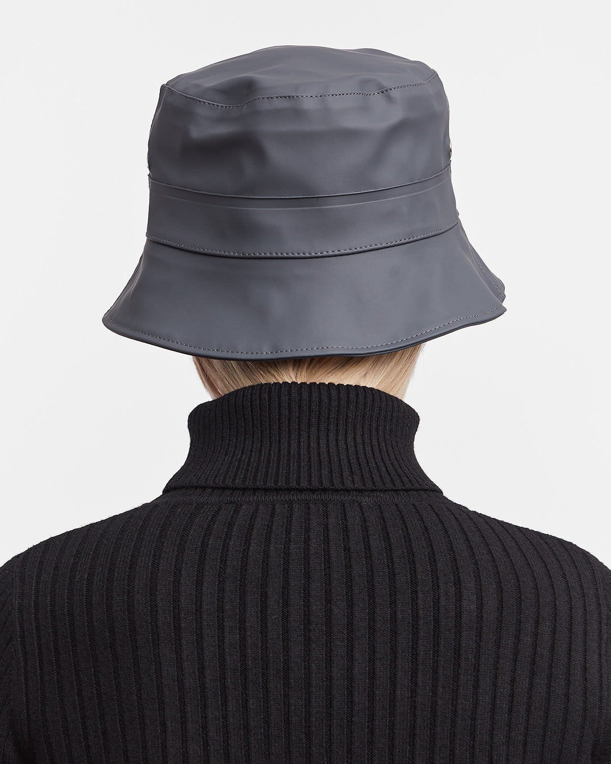 A woman with Bucket Hat in color charcoal by Stutterheim seen from behind