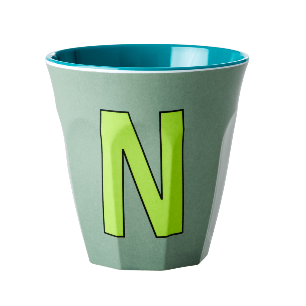 Melamine cup by Rice by Rice in the colors green, light green, and teal with the letter "N"