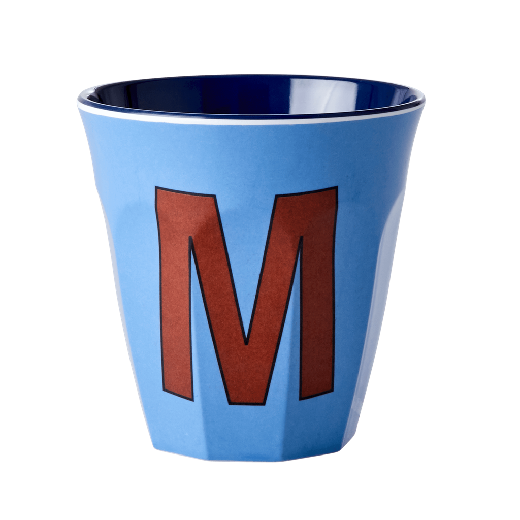 Melamine cup by Rice by Rice in the colors light blue, brown, and blue with the letter "M"