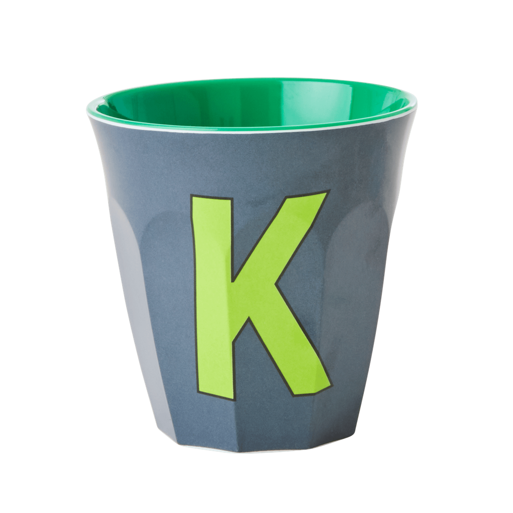Melamine cup by Rice by Rice in the colors grey, light green, and green with the letter "K"