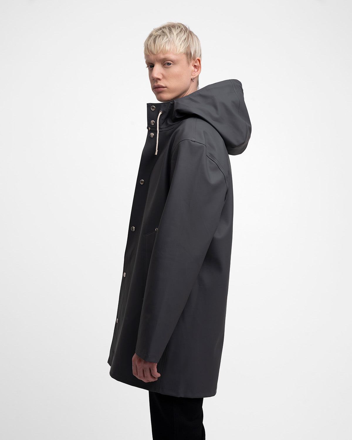 A man with a Raincoat in color charcoal by Stutterheim