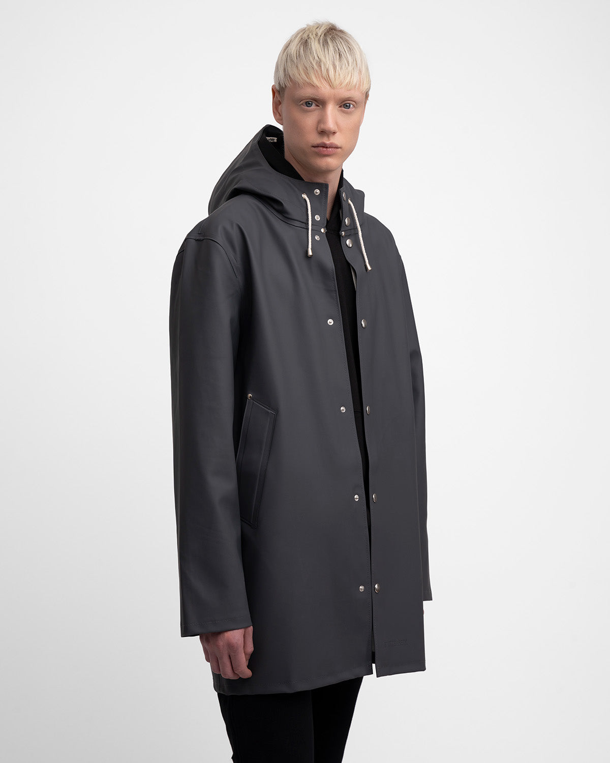 A man with a Raincoat in color charcoal by Stutterheim