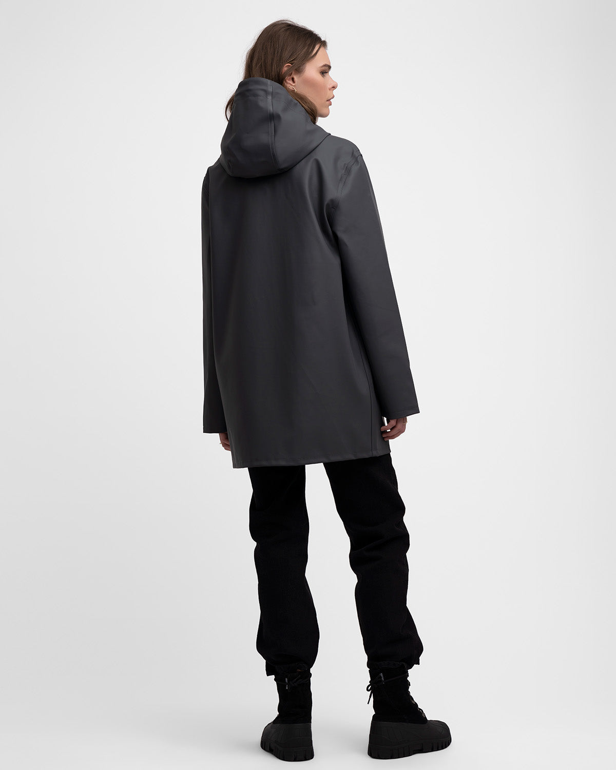 A woman with a Raincoat in color charcoal by Stutterheim